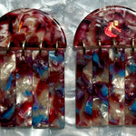 close up of acrylic Fringe Earrings in red, white and blue