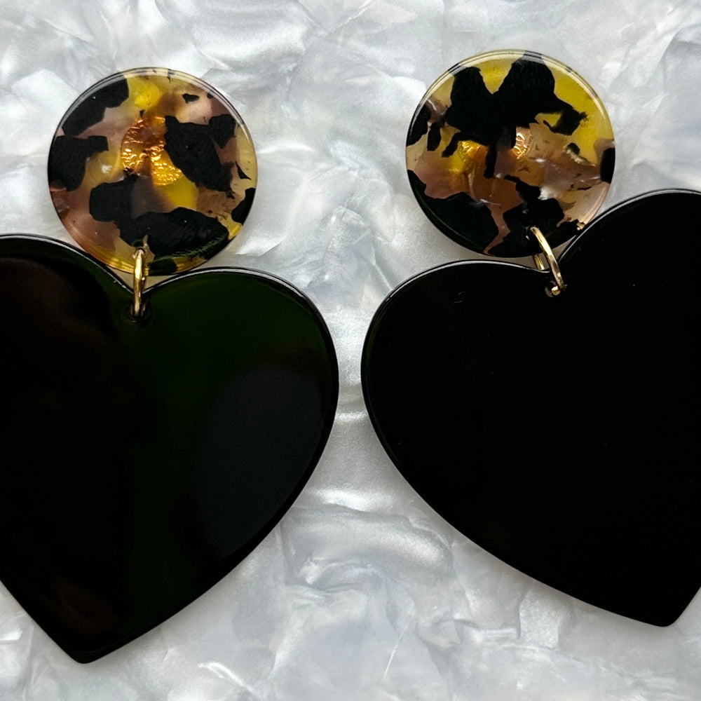 close up of acrylic Heart Earrings in Undercover Lover, black, yellow and brown