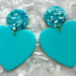 close up of acrylic Heart Earrings in Waterfalling in Love and Blue 