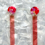 close up of acrylic Matchstick Drop Earrings in Hot red and pink