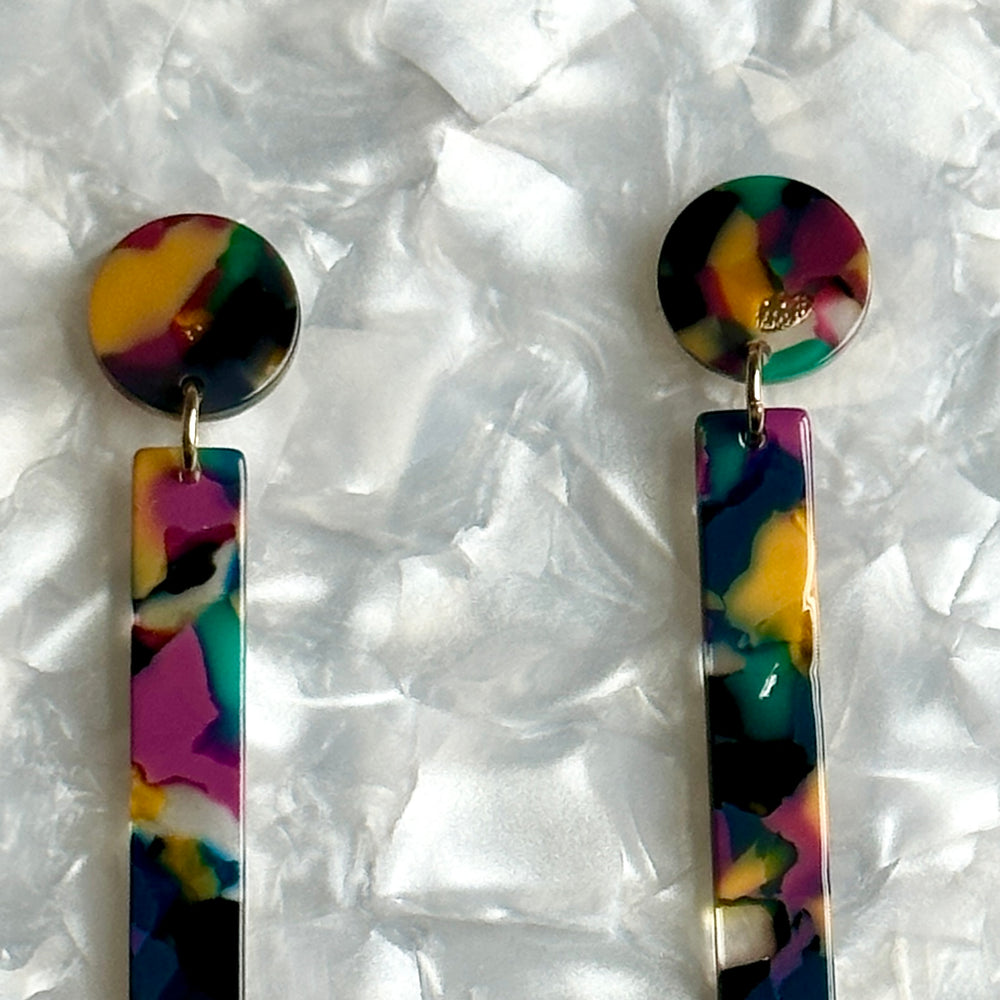 close up of acrylic Matchstick Drop Earrings in Jungle Punch yellow, green, black and deep purple