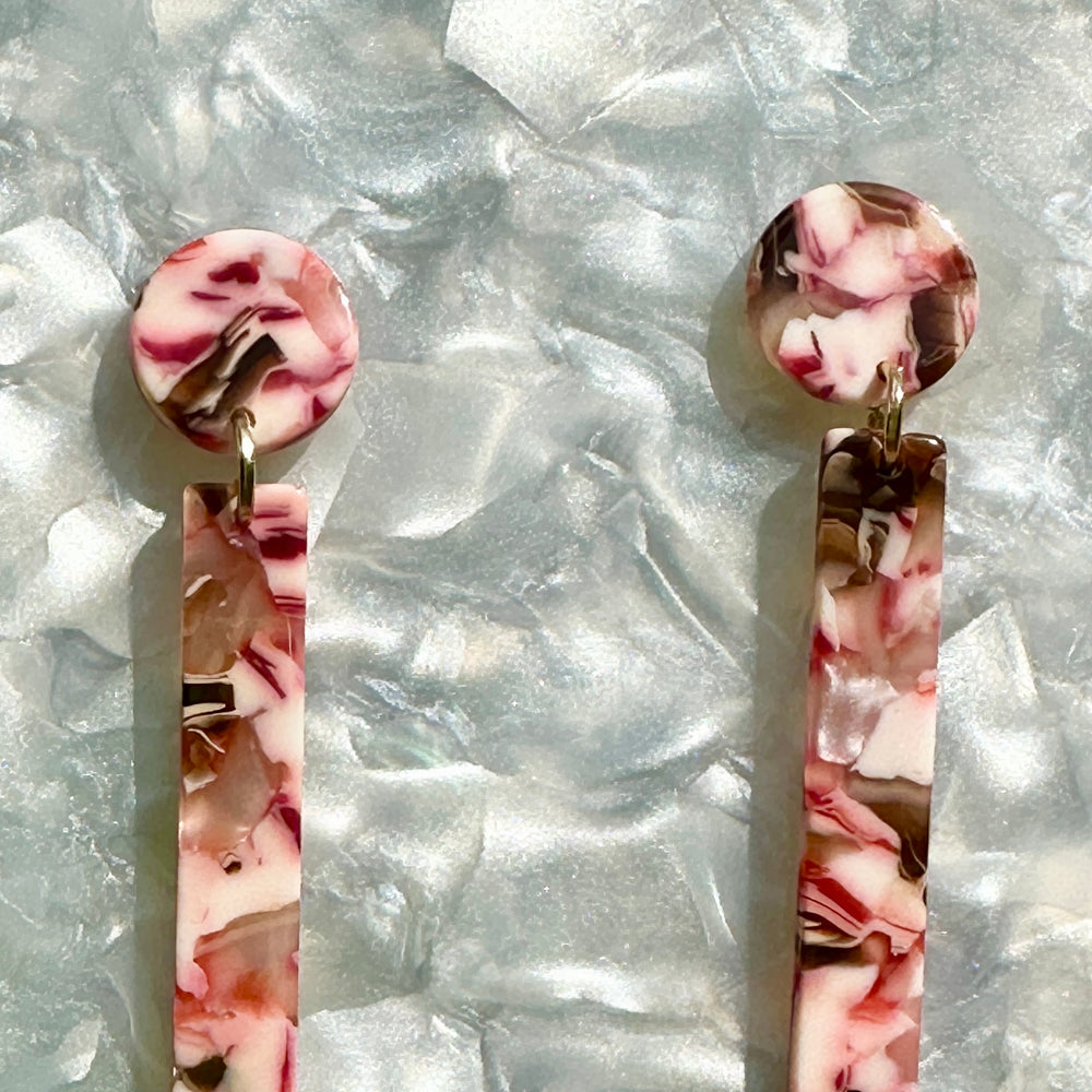 woman wearing acrylic Matchstick Drop Earrings in Peppermint Kiss red, white and brown