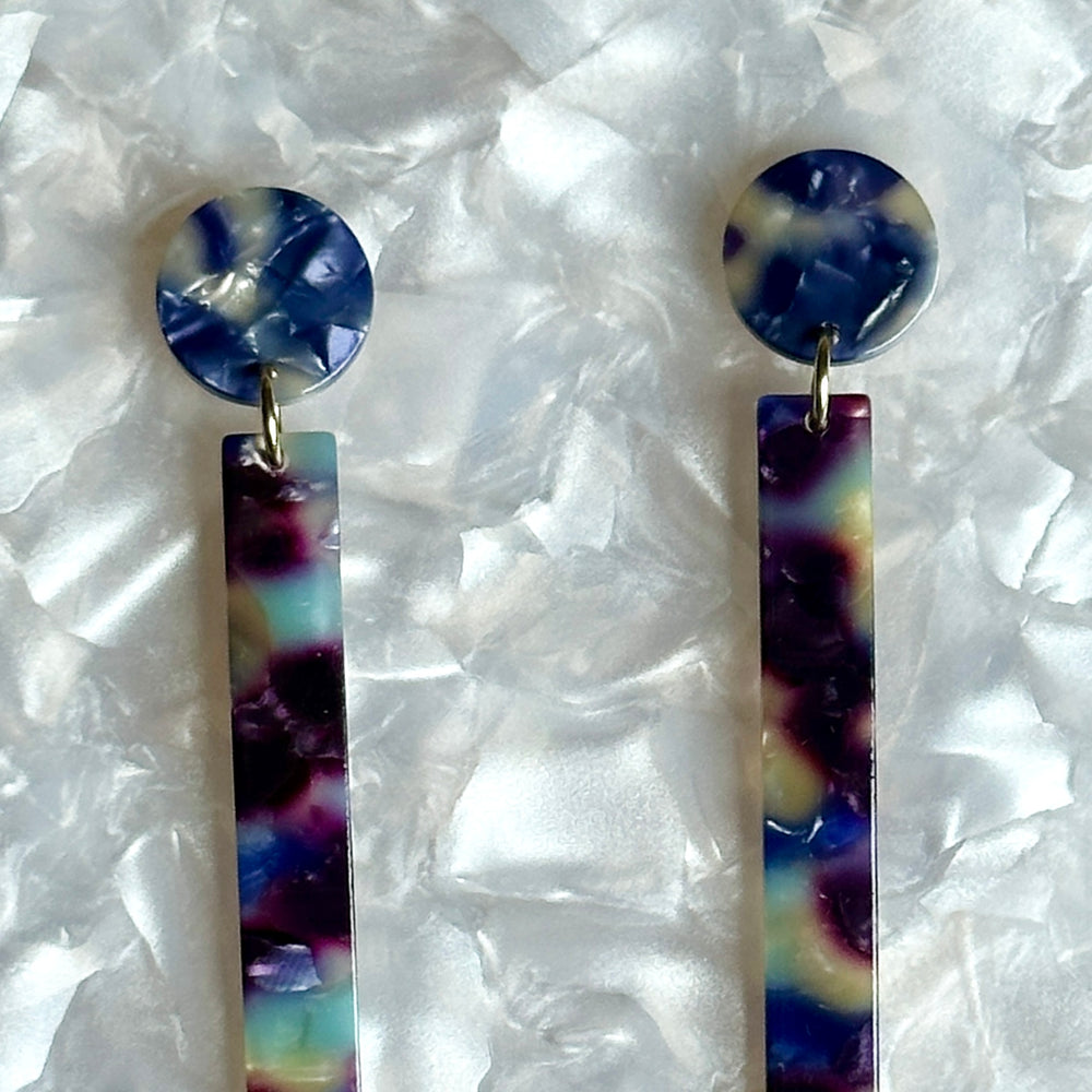 woman wearing acrylic Matchstick Drop Earrings in Reign Check blue and purple