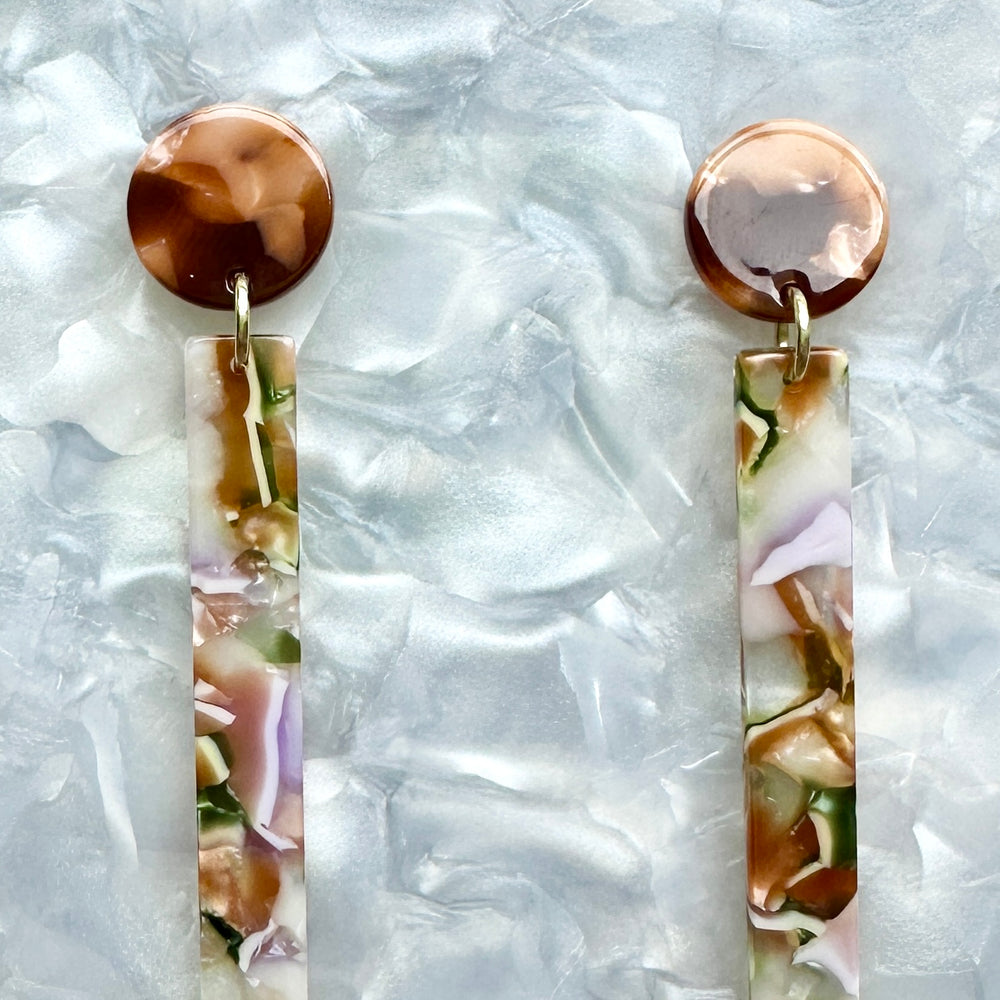 close up of acrylic Matchstick Drop Earrings in Secret Garden lavender, green, brown and white