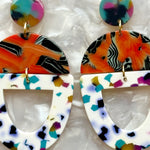 woman wearing acrylic Open Tab Drop Earrings in orange and multicolor