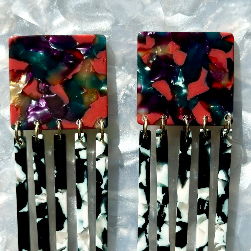 woman wearing acrylic Square Fringe Earrings in red, green, purple, gold, black and white