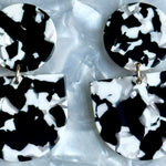 woman wearing acrylic Tab Drop Earrings in black and white