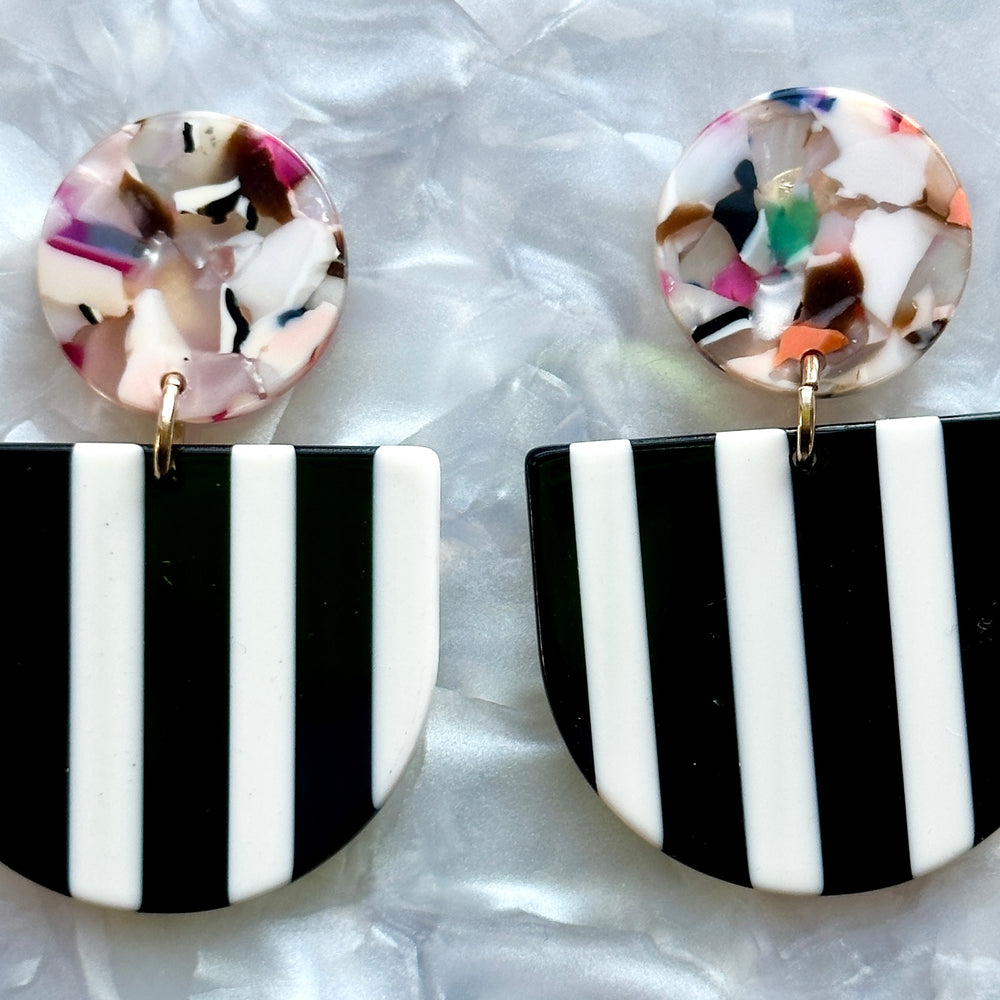 close up of acrylic Tab Drop Earrings in black and white stripe with multicolor