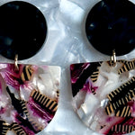 close up of acrylic Tab Drop Earrings in pink and black