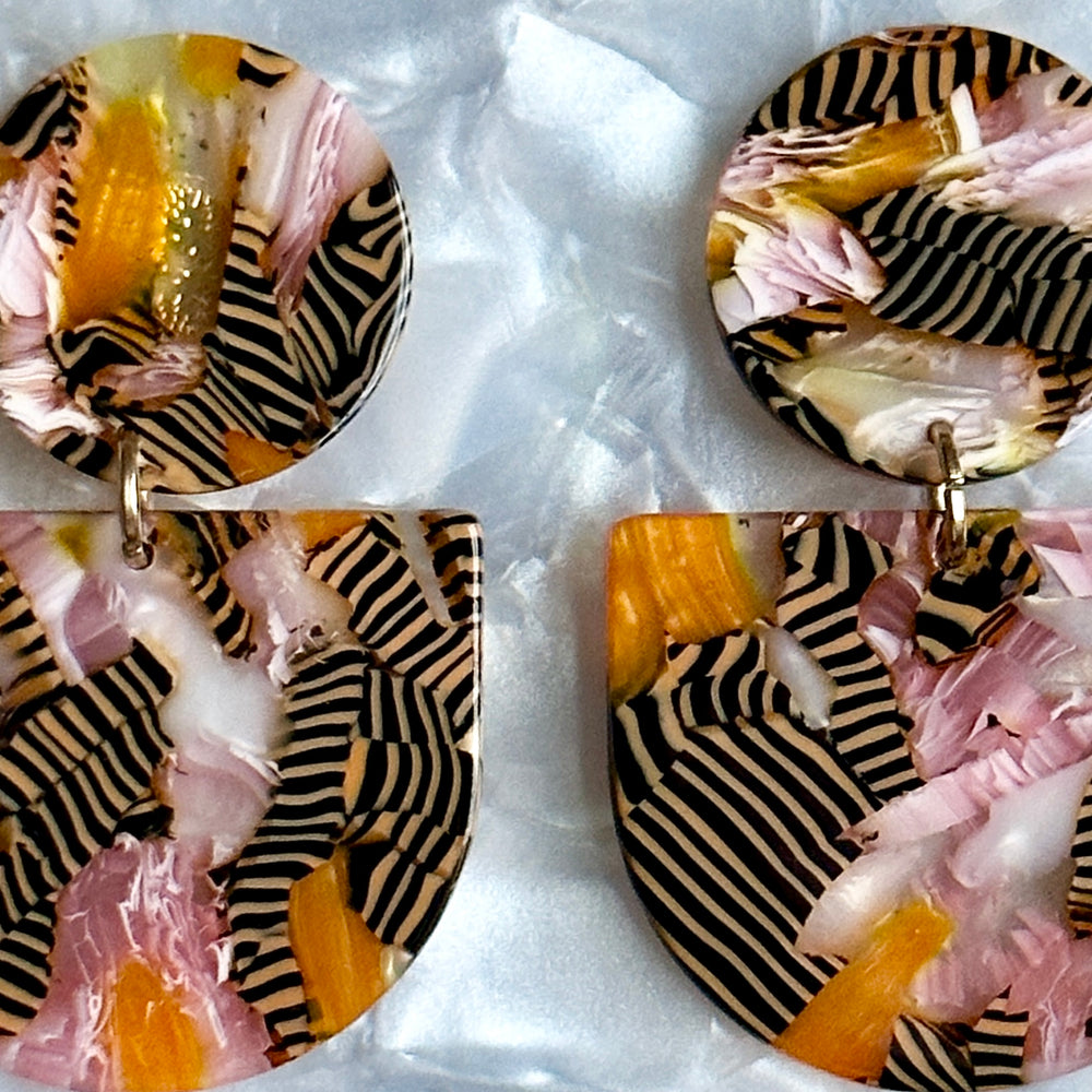 woman wearing acrylic Tab Drop Earrings in pink, orange and black