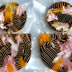 woman wearing acrylic Tab Drop Earrings in pink, orange and black