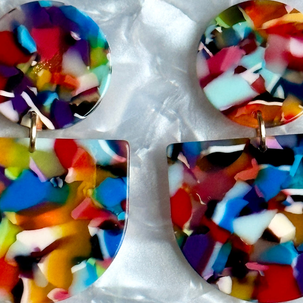 close up of acrylic Tab Drop Earrings in rainbow multicolor