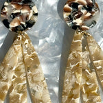 close up of acrylic flower Petal Drop Earrings in beige and brown