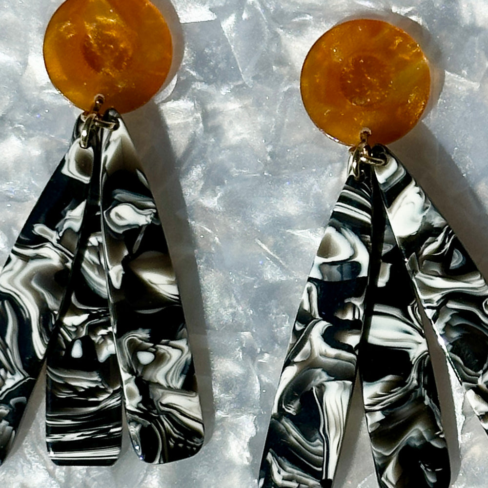 close up of acrylic flower Petal Drop Earrings in black, brown and white