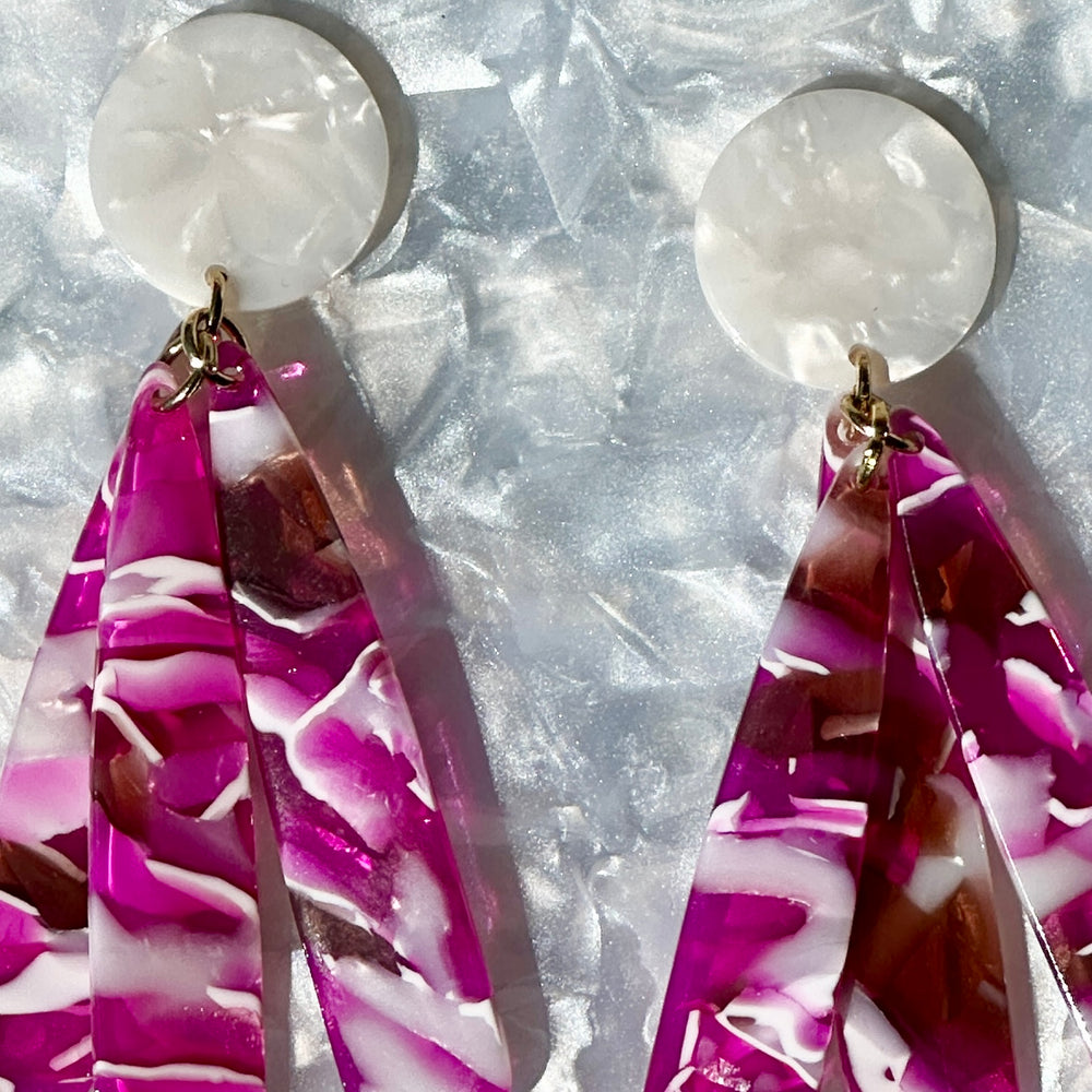 close up of acrylic flower Petal Drop Earrings in fuchsia and white