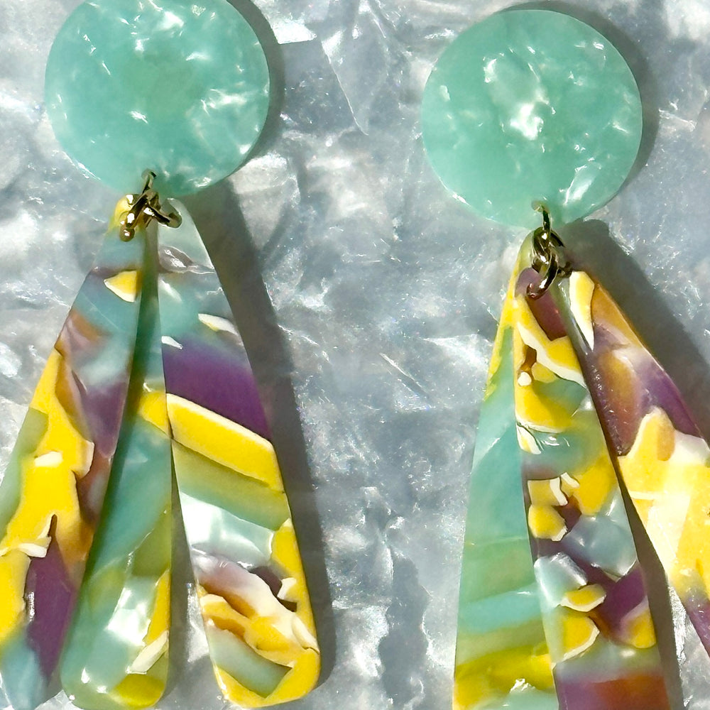 close up of acrylic flower Petal Drop Earrings in green, yellow and purple