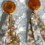 close up of acrylic flower Petal Drop Earrings in orange, blue and white