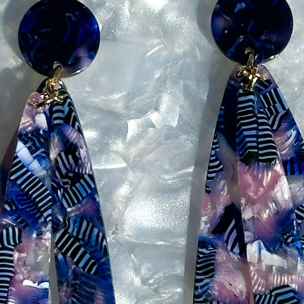 close up of acrylic flower Petal Drop Earrings in purple, pink and blue