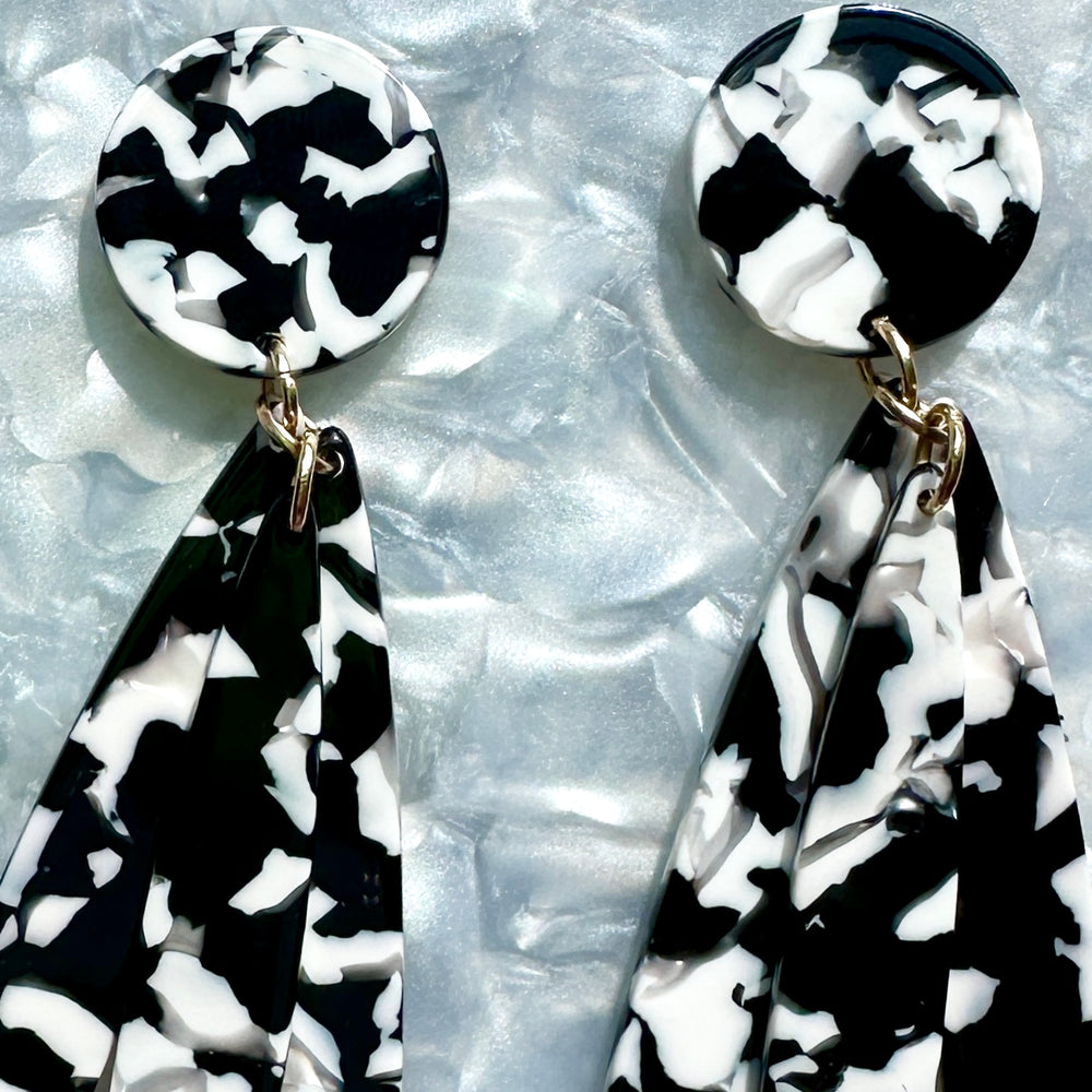 woman wearing acrylic flower Petal Drop Earrings in white and black