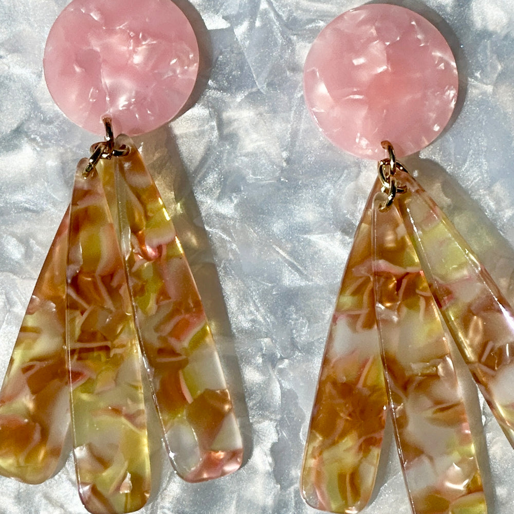 close up of acrylic flower Petal Drop Earrings in yellow, pink and brown