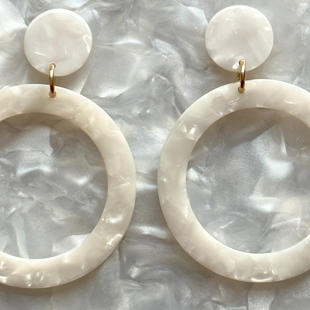 woman wearing  acrylic open circle drop earring in white