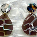 close up of mini acrylic teardrop earring in grey and iridescent and dark multicolor