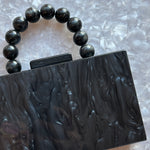 clutch purse with beaded handle in black acrylic_close up