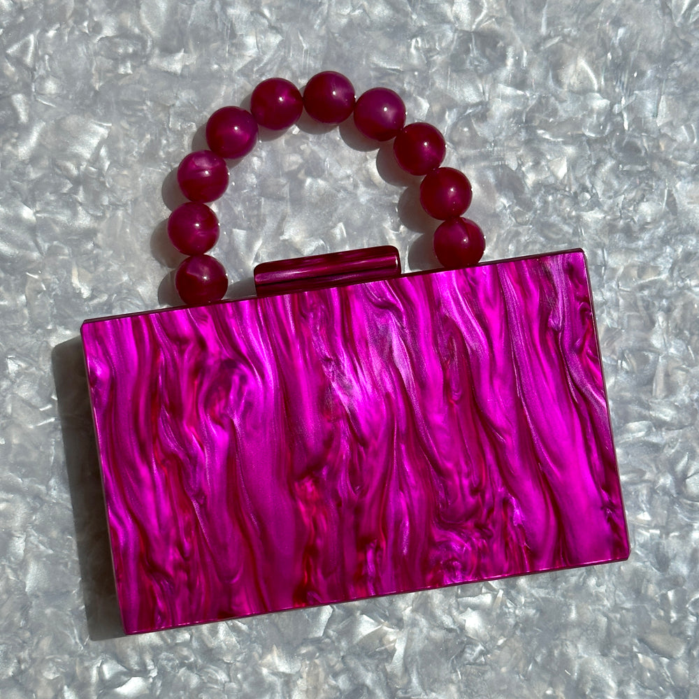 clutch purse with beaded handle in magenta pink acrylic