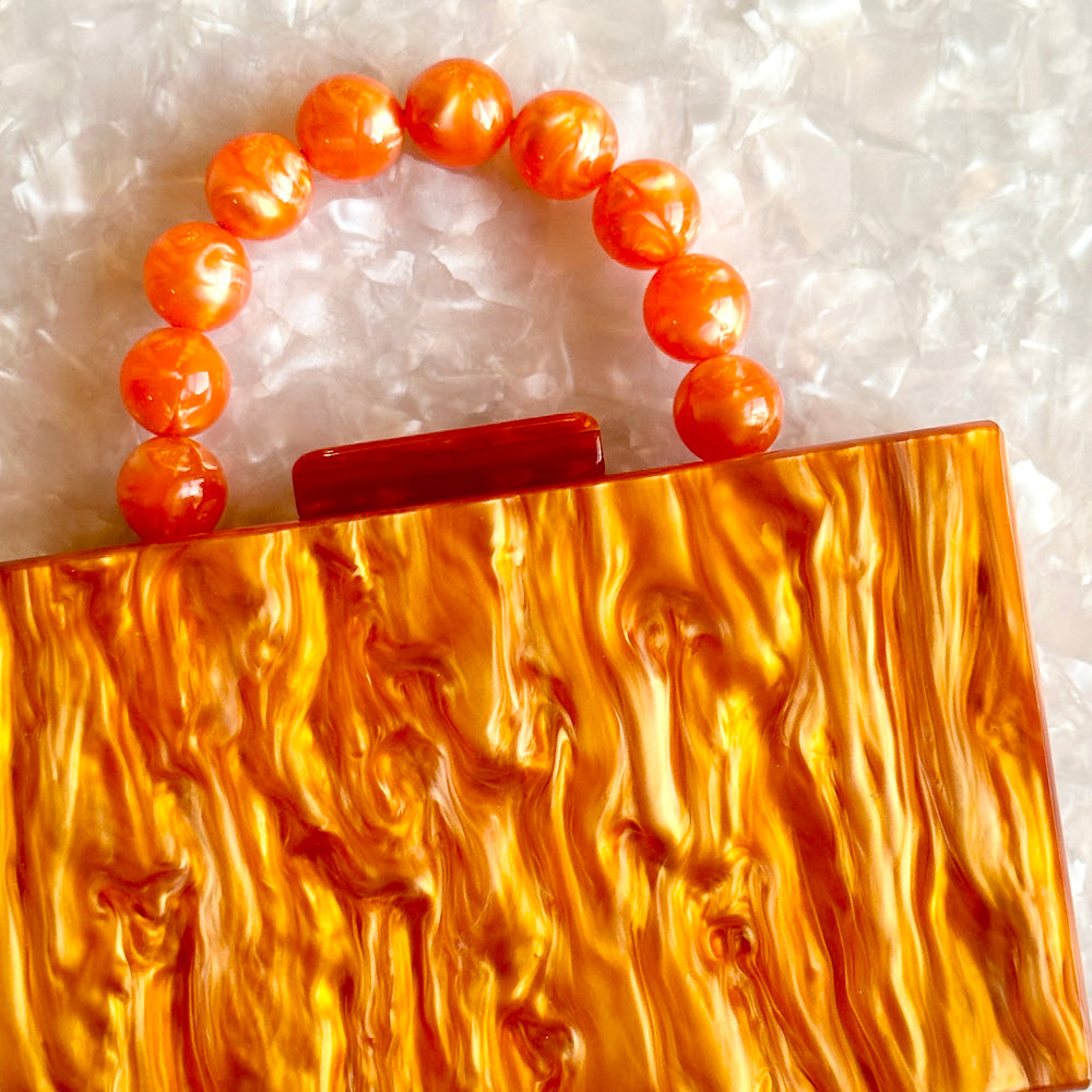 clutch purse with beaded handle in orange acrylic_interior