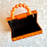 clutch purse with beaded handle in orange acrylic_interior