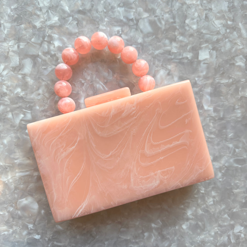 clutch purse with beaded handle in peach pink acrylic