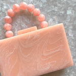 clutch purse with beaded handle in peach pink acrylic_close up