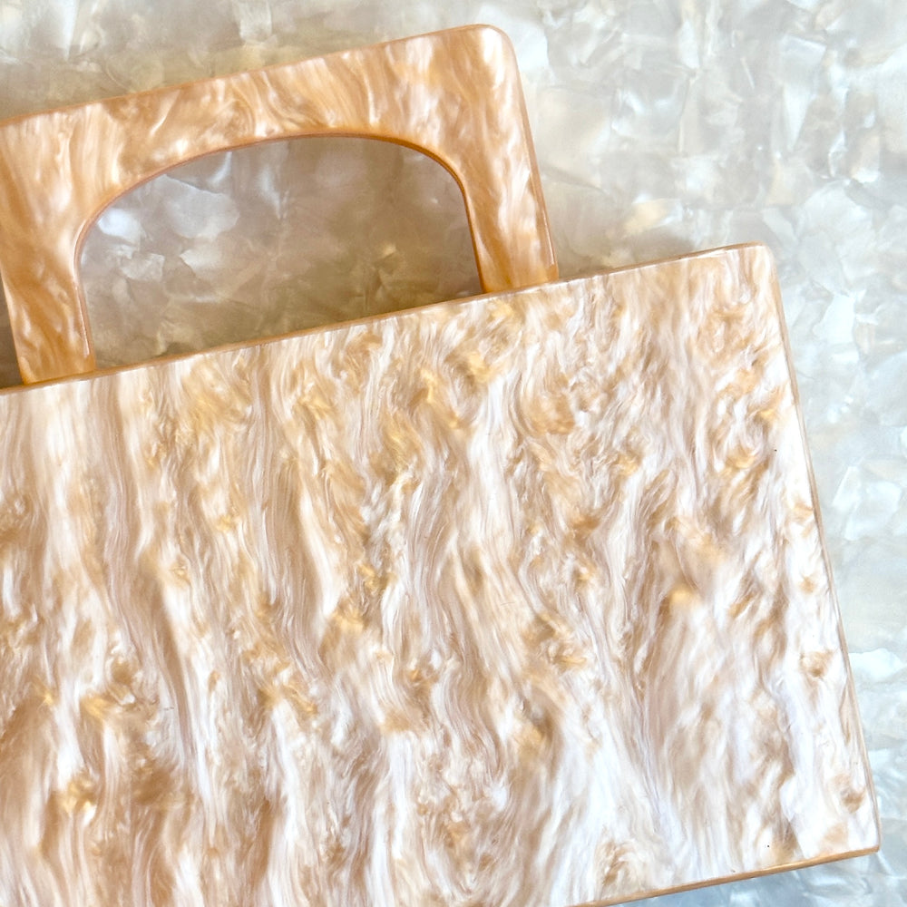 clutch purse with handle in pearly beige acrylic_close up