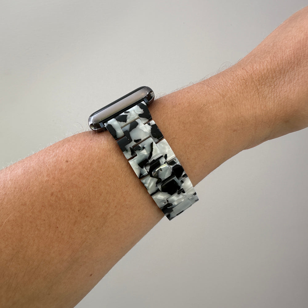 side view of woman wearing acrylic Apple Watch Band in Pearly Black and Whiteside view of woman wearing acrylic Apple Watch Band in Pearly Black and White