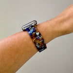 side view of woman wearing acrylic Apple Watch Band in Serving Looks purple amber and light blue