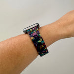 side view of woman wearing acrylic Apple watch band in dark multicolor teal green purple navy blue golden yellow magenta pin