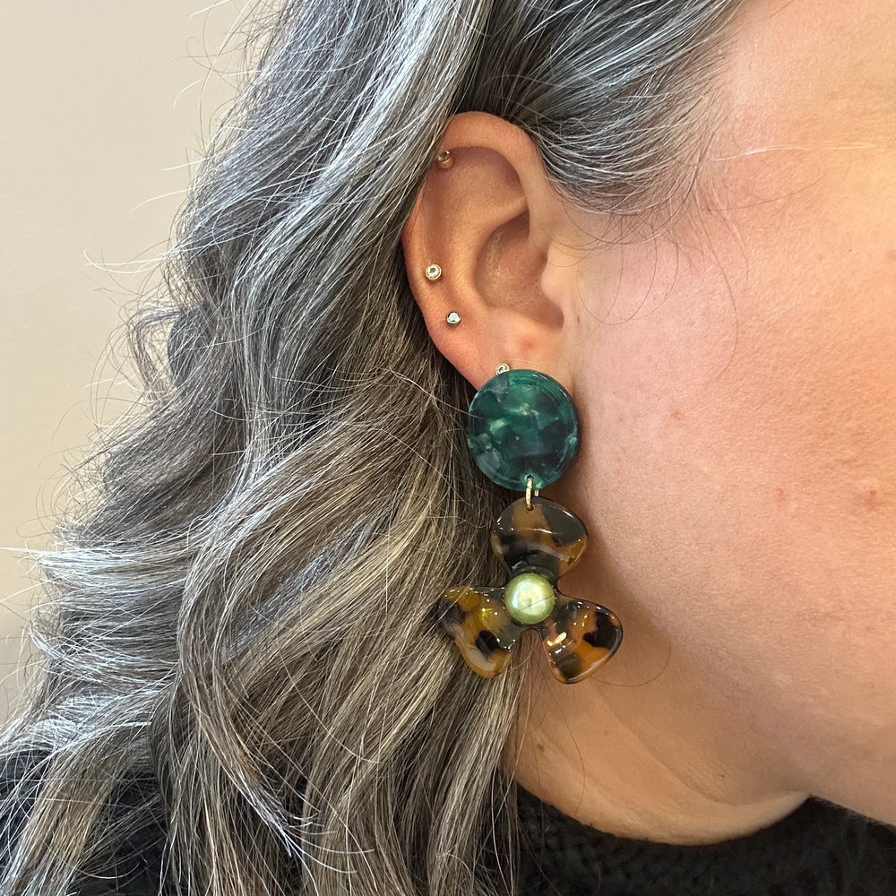 woman wearing Acrylic Flower Drop Earrings in Emerald green and tortoise