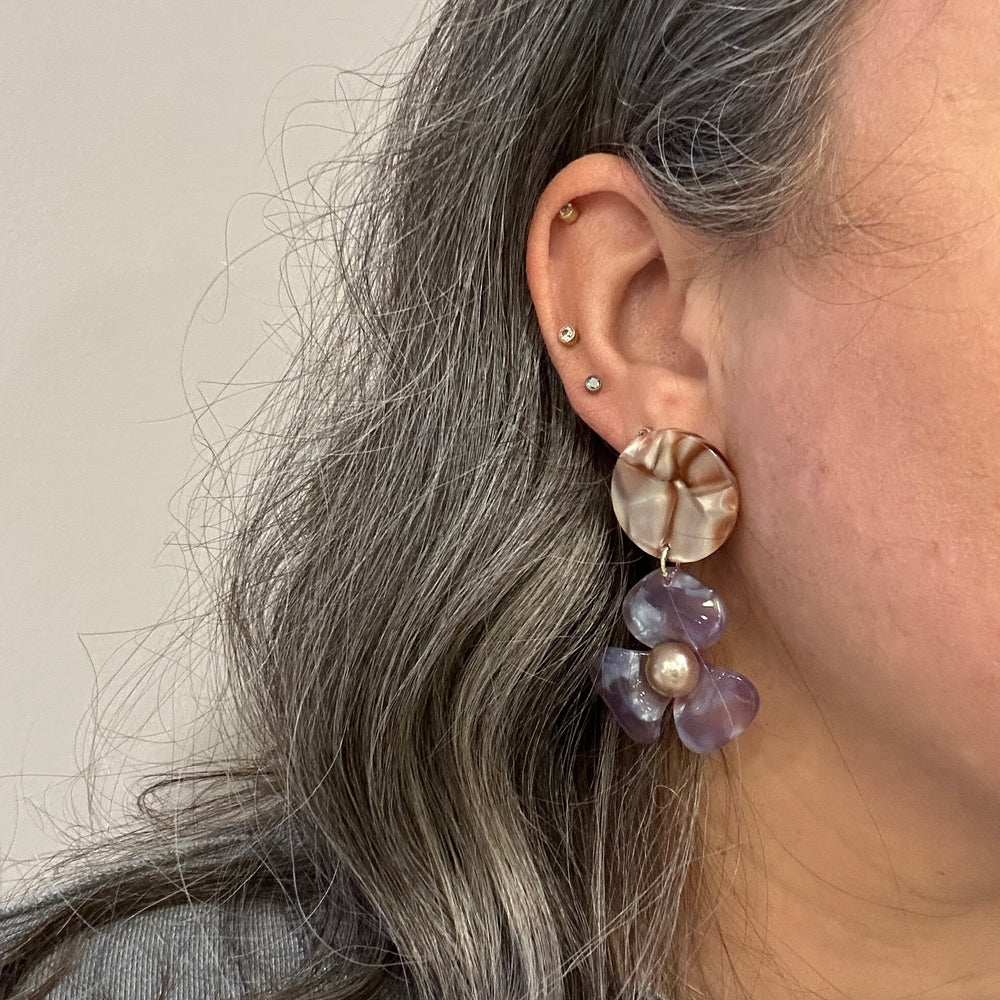 woman wearing Acrylic Flower Drop Earrings in purple and brown