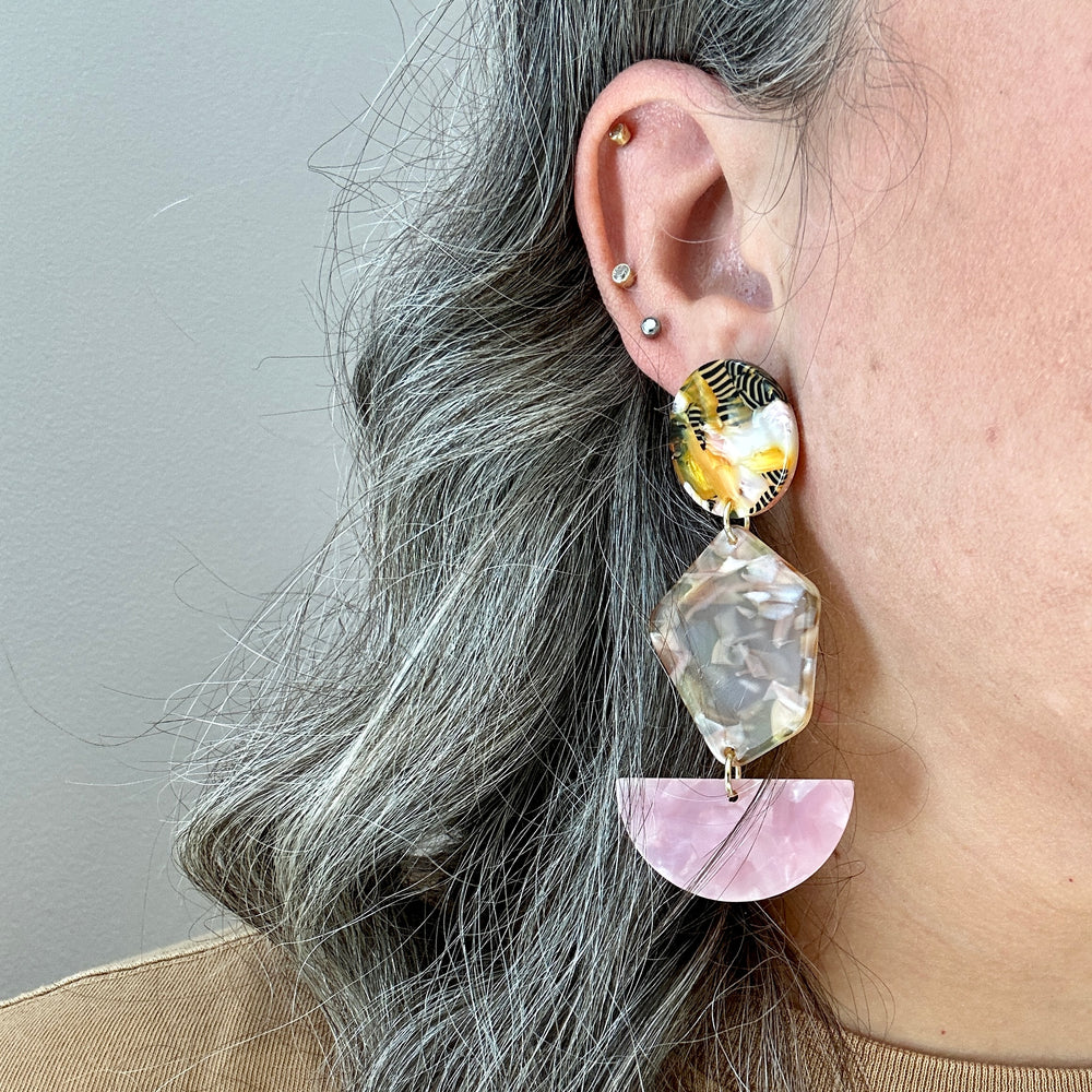 woman wearing Acrylic Pendulum Drop Earrings in Centerpiece of Attention, pink, black, white and orange 