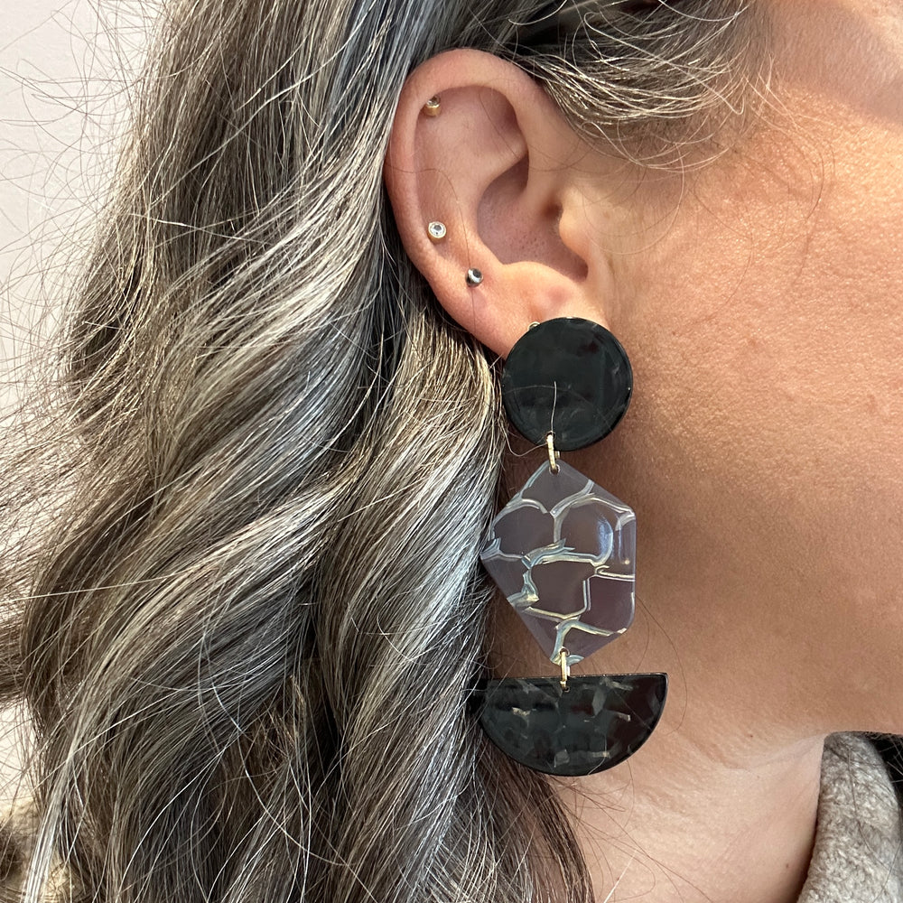 woman wearing Acrylic Pendulum Drop Earrings in Do Not Disturb, black and sliver