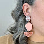 woman wearing Acrylic Pendulum Drop Earrings in peachy pink and brown mix