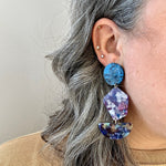 woman wearing Acrylic Pendulum drop earrings in blue and purple 