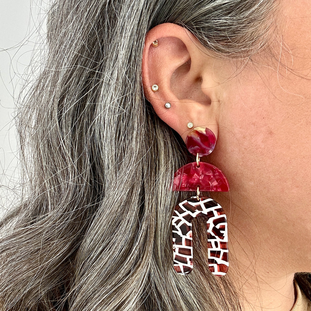 woman wearing Acrylic arch drop earring in red