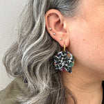 woman wearing a  Acrylic convertible hoop earrings in a mix of black and multicolor 