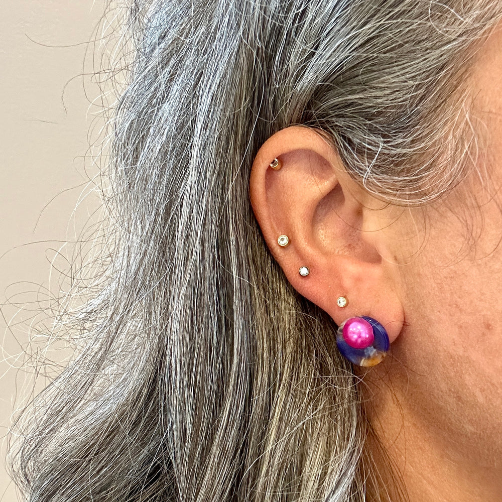 woman wearing Acrylic stud earring in deep purple, pink and yellow 