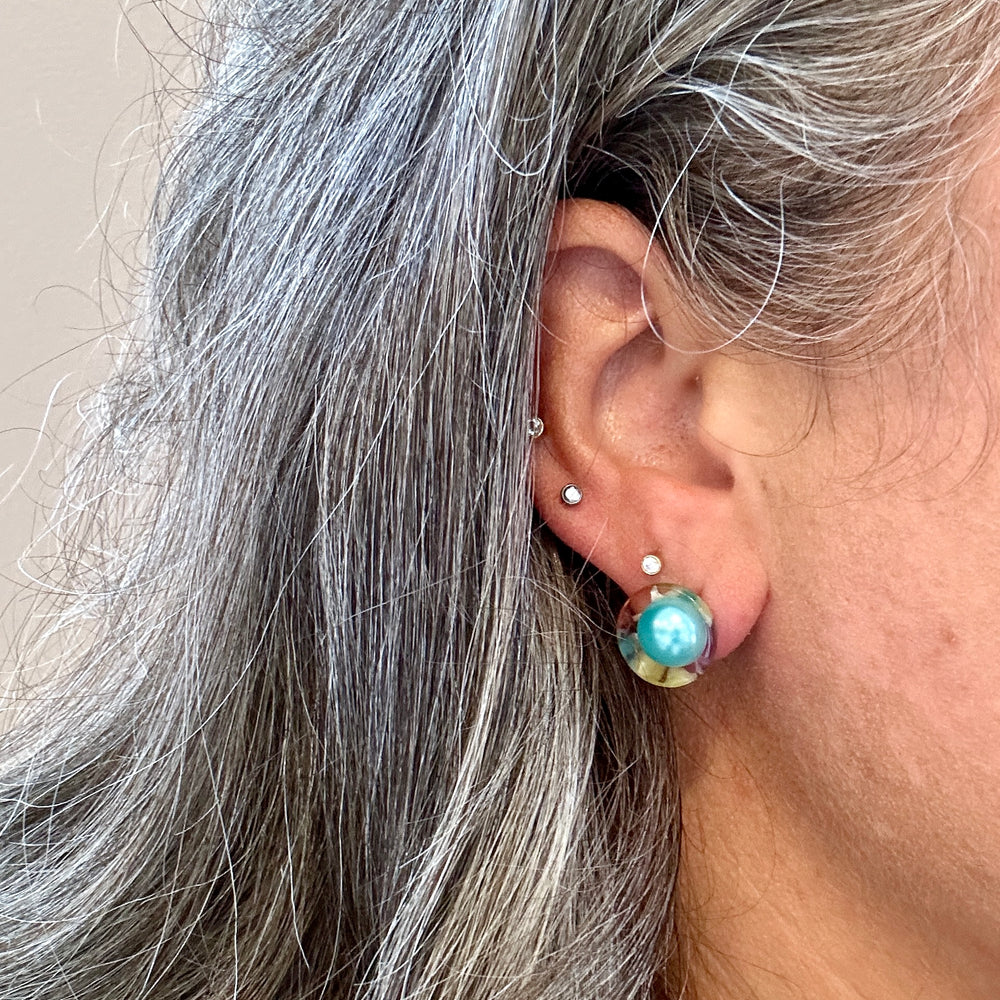 woman wearing Acrylic stud earring in light blue, red and yellow 