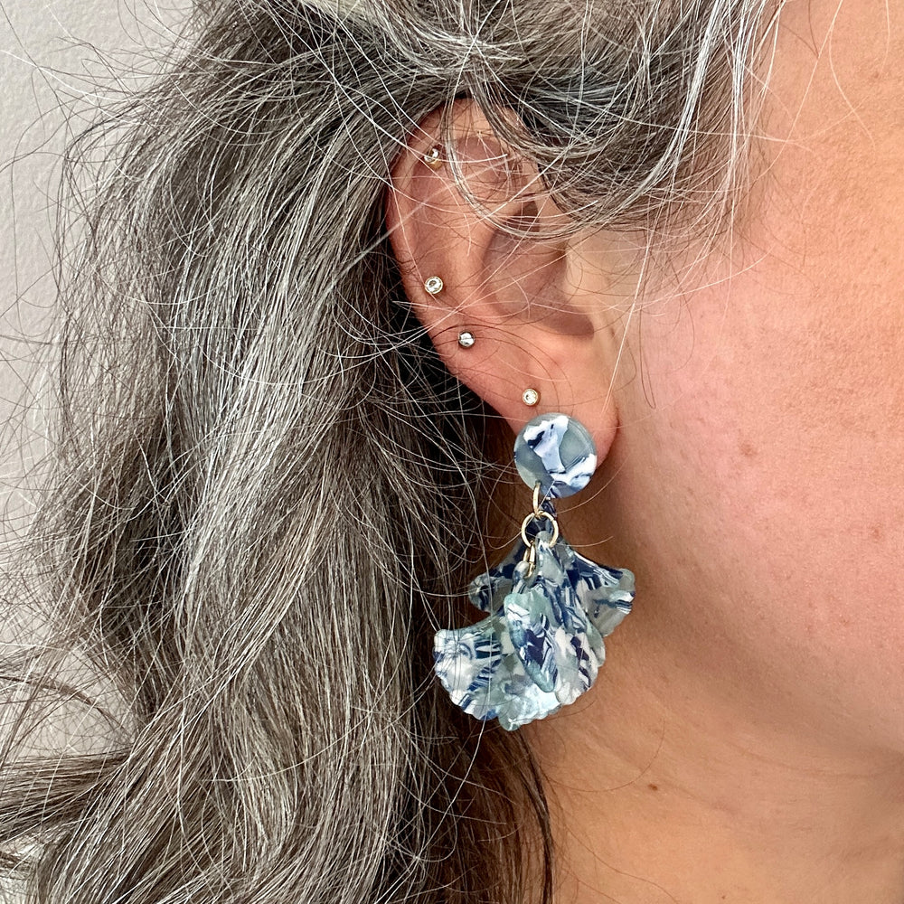 woman wearing Mini acrylic flower Petal Drop Earrings in blue