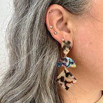 woman wearing a Acrylic Hemisphere drop earrings in multicolor, black and white 