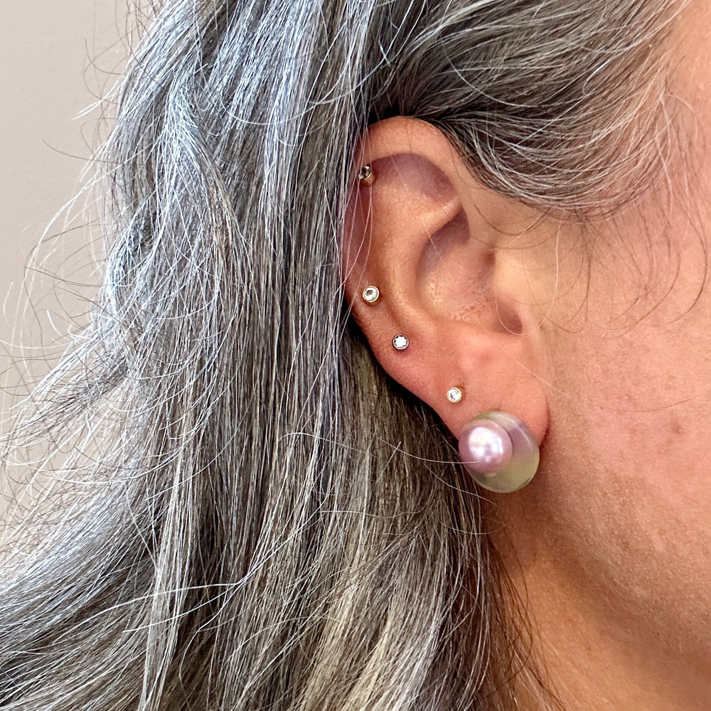 woman wearing a Acrylic stud earring in  purple, green and yellow 