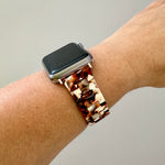 woman wearing acrylic Apple Watch Band in Burnt Umber in brown and white